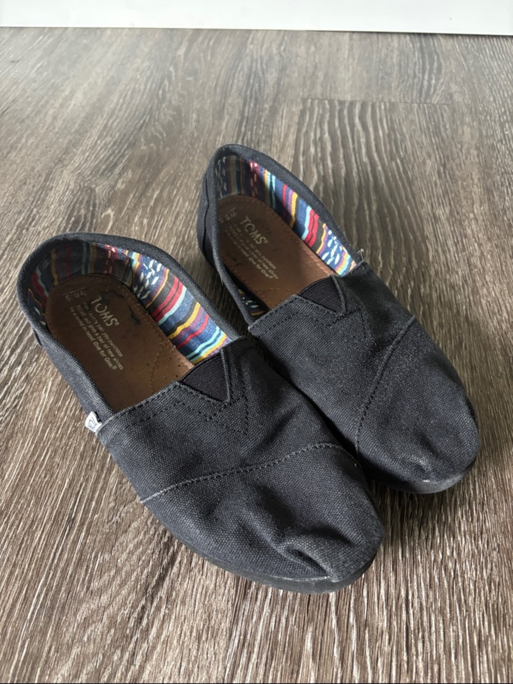Toms Black Canvas Slip-On Sneakers with Multicolor Striped Lining